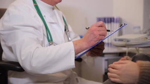 Doctor Taking Notes During Patient Consultation