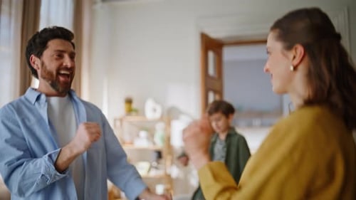 Happy Family Dancing Together in Living Room