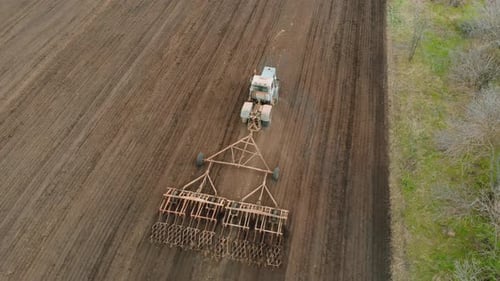 Tractor Tilling Farmland Aerial Drone Shot