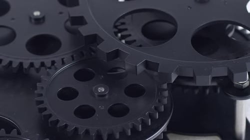 Black Gears Working Together in Close Up