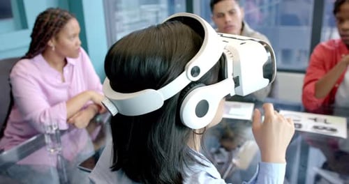 Using VR headset, woman interacting with virtual environment in office meeting