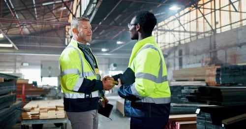 Handshake, teamwork and men in discussion in warehouse for construction, logistics and maintenance