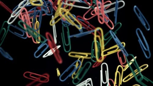Colorful Paperclips Floating on a Black Background
