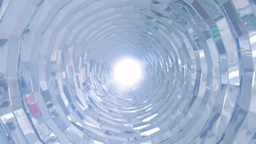 A rotating silver metal chrome shiny tunnel with walls of ribs and lines in the form of a circle