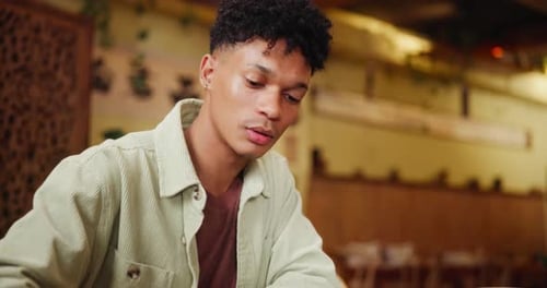 Seafood, chopsticks and man at restaurant with sushi, eating and asian cuisine for brunch