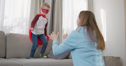Boy Superhero Jumps into Mother's Arms at Home