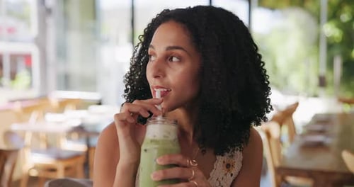 Smile, woman and relax with drink at cafe with iced matcha latte, refreshing smoothie