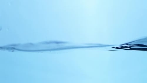 Bubbles float upward in clear blue water, representing purity, health, and the continuous flow of cl