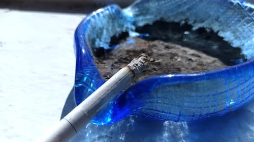 The wind blows a smoking cigarette