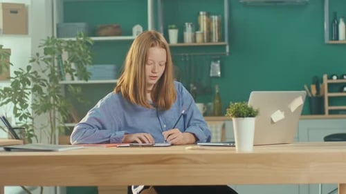 Girl Studies At Laptop In Home Setting