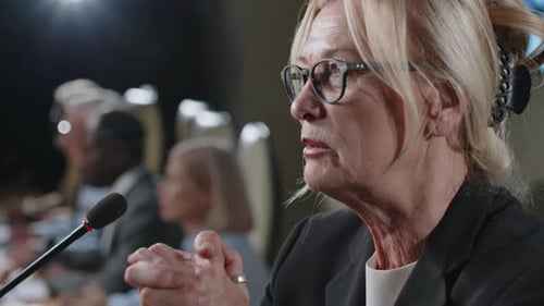 Woman Speaks at Corporate Conference with Microphone