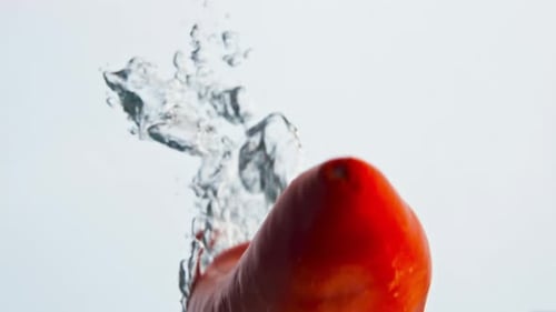 Red Chili Pepper Falling Into Water