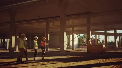 Diverse Team of Specialists Walk Through Garage Level of Industrial / Commercial Building Construct