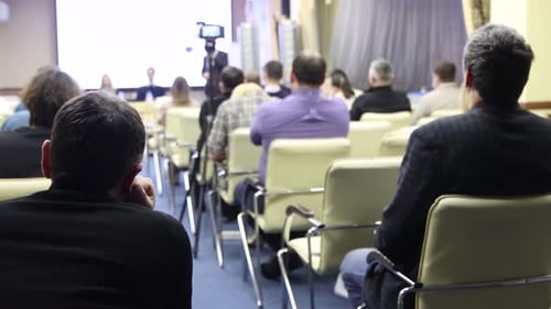 Audience Listening to Presentation in Conference Room