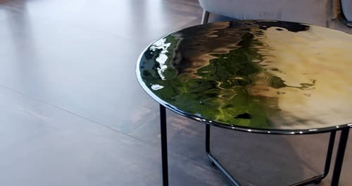 Close Up of Reflective Chrome Table in Modern Home