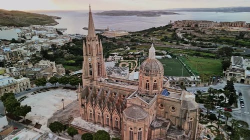 Historic church and scenic landscape of Malta at sunset