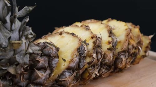 Sliced Pineapple on Wooden Board