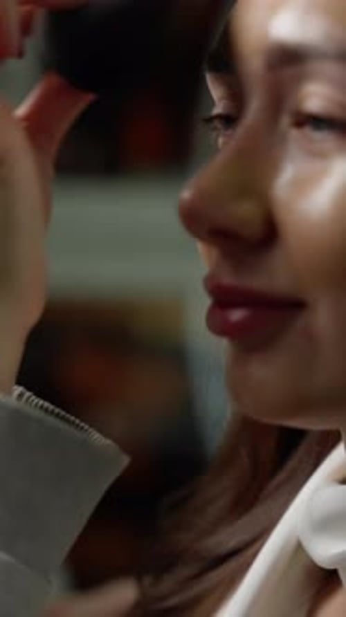 Woman Applies Makeup With a Black Sponge