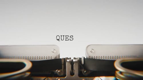 Old mechanical typewriter typing Quest For Truth in a close-up view.