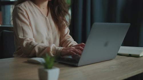 Woman working on her computer in her home