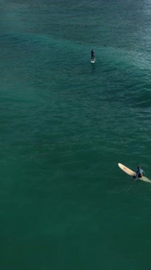 Vertical Video Cinematic Coastal Thrills Aerial View of Surfers in Alanya Turkey