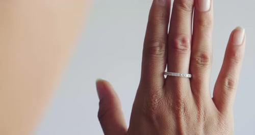 Close up of a girl's hand trying a diamond ring. Concept: jewelry, fashion, style