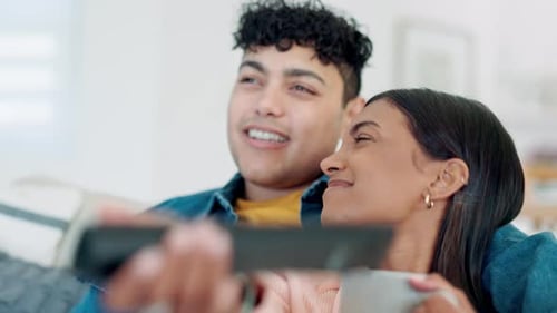 Couple Relaxing on Couch Watching Television