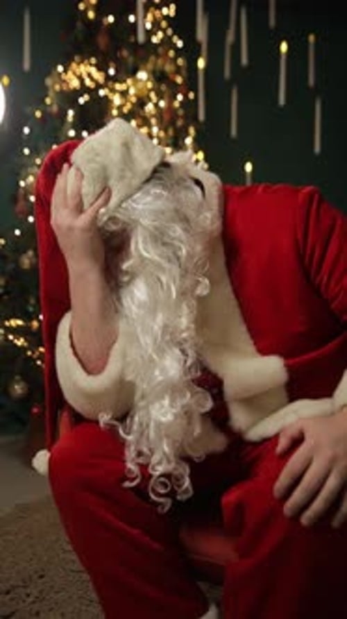 Man in Santa Costume Feeling Stressed and Depressed