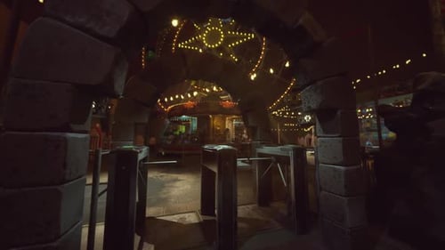 Empty Amusement Park Entrance Illuminated By String Lights at Night