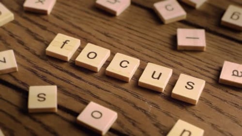 Letter Blocks Spell Focus on Wood Surface
