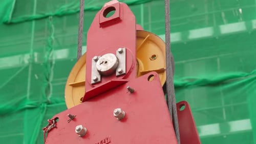Hook Block Of A Tower Crane Working With Scaffoldings In Background. close up