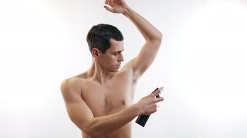 Man Applies Deodorant After Shower on White Background