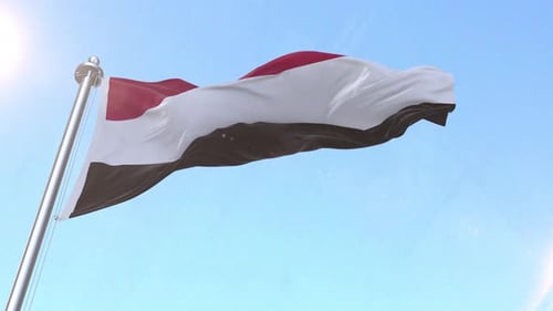 Realistic Yemen National Flag Waving in Blue Sky