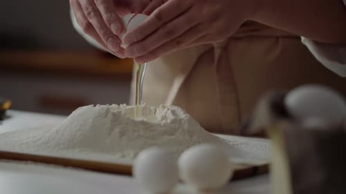 Spaghetti With Their Own Hands, A Woman Baker Breaks An Egg The Yolk Falls Into The Flour