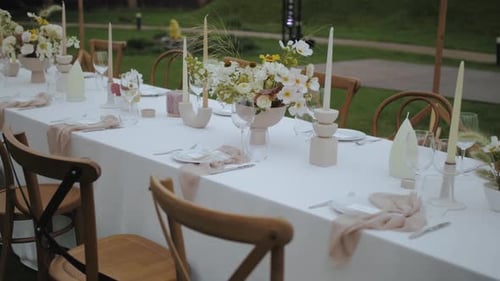 Elegant Wedding Table Setting with Flowers and Candles