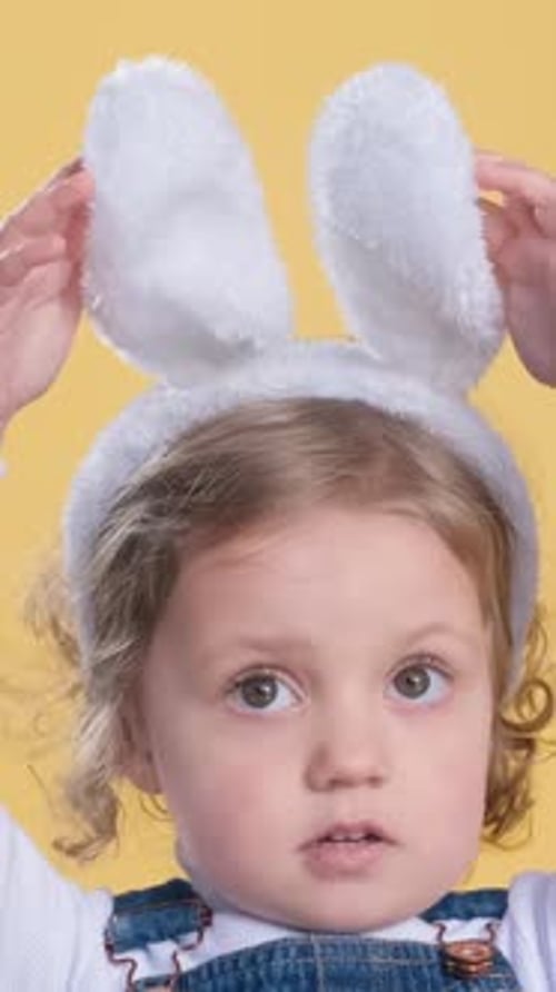 Adorable Child Adjusting Bunny Ears Portrait