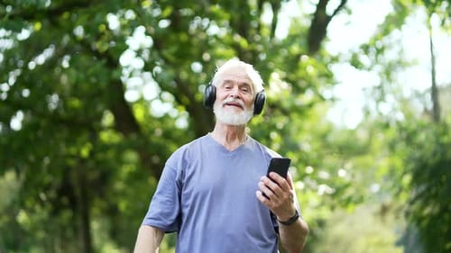 Senior Man Listening to Music While Walking