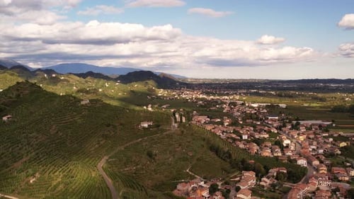 Aerial panoramic landscape view over the famous prosecco hills with vineyard rows, Italy, on a cloud