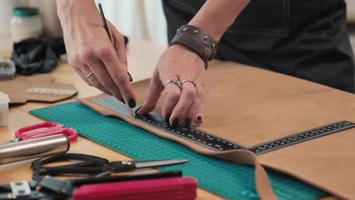 Woman Cutting Leather with Knife and Ruler