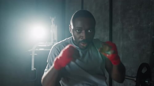 Portrait Aggressive Man Boxer in Gym African American Sportive Focused Sweated Fighter During Boxing