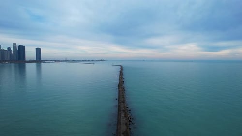 Drone Skyscrapers and Blue Sea Water Under Dark Gloomy Cloudy Sky