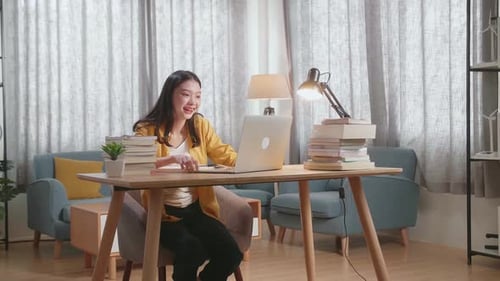 Woman Video Chatting at Desk with Laptop