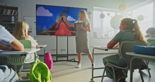 Geology Class Female Teacher with Tablet Computer Teaching Primary School Children Using Digital