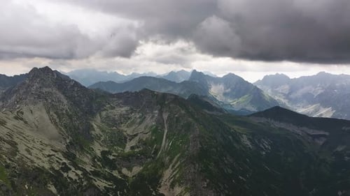 Majestic mountain ranges under a dramatic cloudy sky in stunning wilderness