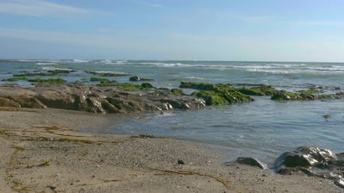 Small waves crashing on the beach.