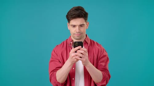 Man Celebrates Good News on Mobile Phone