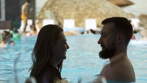 Happy couple embracing in outdoors swimming pool
