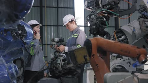 Caucasian Engineers Celebrating Success in Robotics Engineering