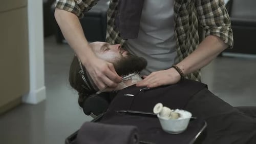 Man Gets Traditional Straight Razor Shave at Barbershop