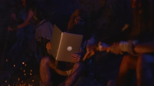 A Caveman Using Modern Technology Within a Primitive and Ancient Setting Scenario